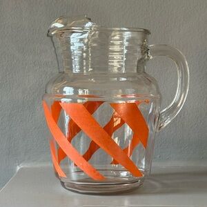 Vintage glass Anchor Hocking pitcher with orange swirl design